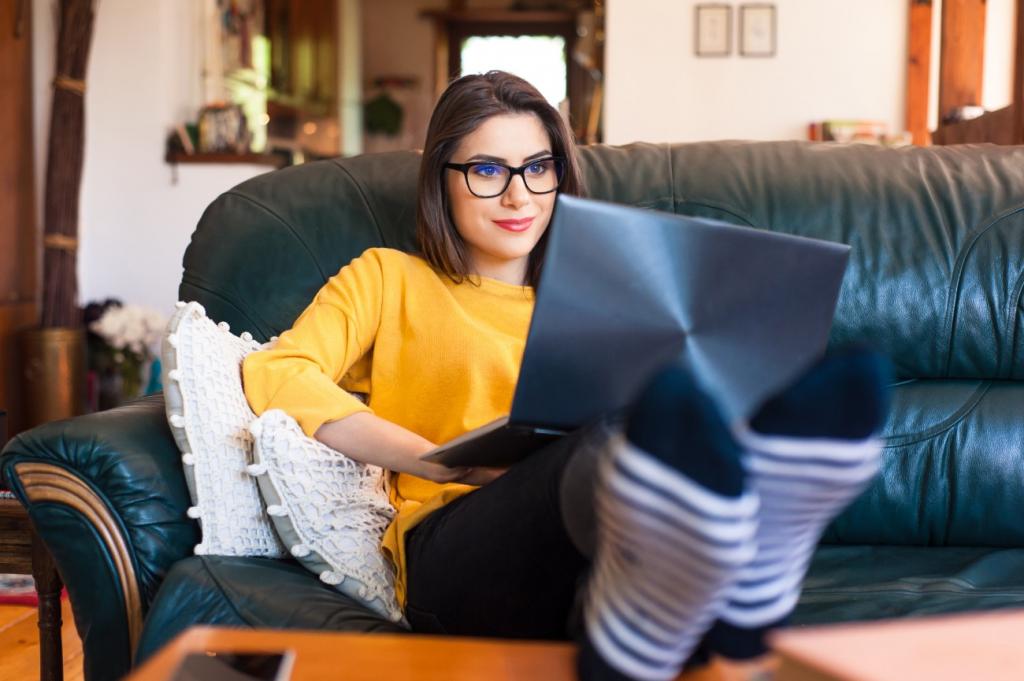 woman lounging on couch with laptop